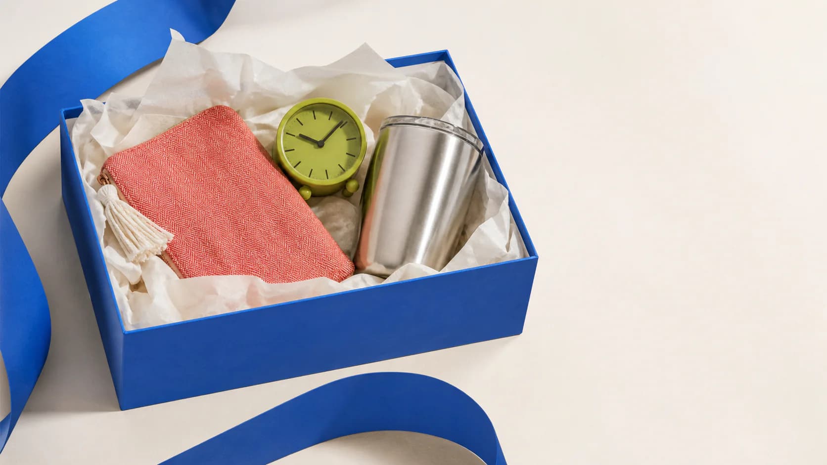 A cobalt JBRB gift box with a pouch, clock, and travel tumbler